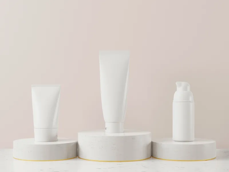 Unbranded white cosmetic tubes and bottles on display stands